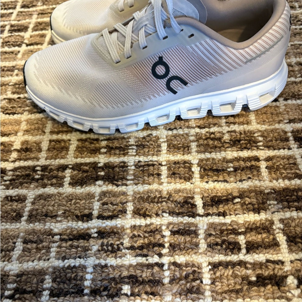 On Running Cream and White Athletic Shoes